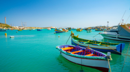A view of traditional fishing boats luzzu in the Marsaxlokk Harbor in Malta